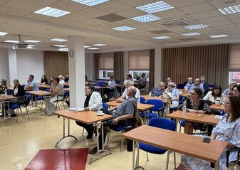 Obrazek przedstawia uczestników konferencji podczas prelekcji.