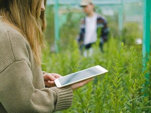 Zdjęcie przedstawia kobietę z tabletem