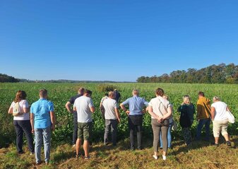 Obrazek przedstawia uczestników konferencji podczas wizyty w gospodarstwie.